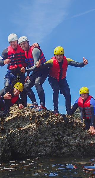Group photo of the guys on the Coasteering part of the Adult Adventure Weekends