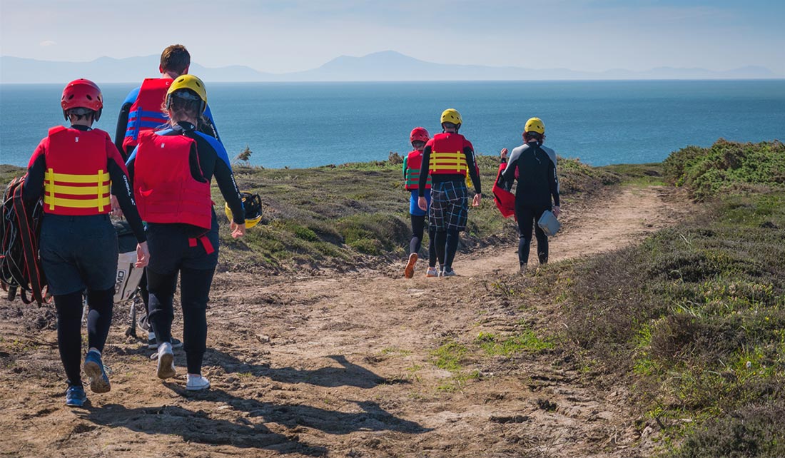 A large group walking back home after completing a Sea Level Traversing challenge