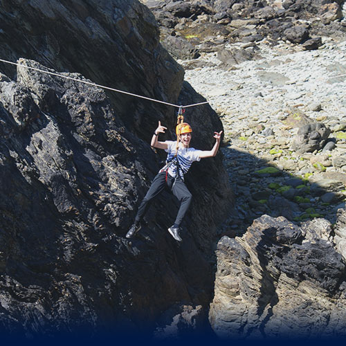 Happy woman poses for the camera on a Zipwire challenge